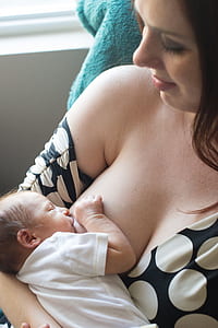baby feeding on woman's breast thumbnail
