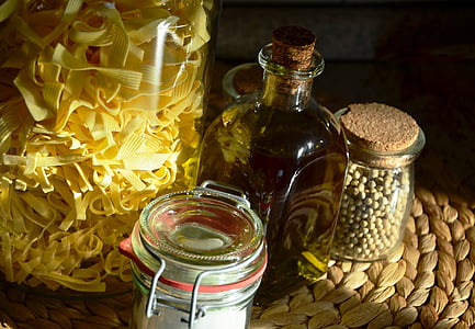 several clear glass jars with herbs thumbnail