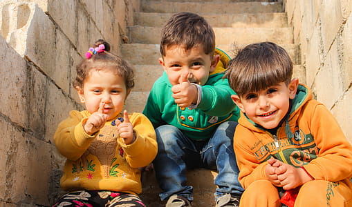Three Children Sitting On Stairs thumbnail