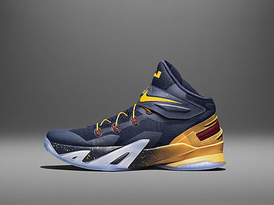 unpaired black and yellow Nike basketball shoe thumbnail