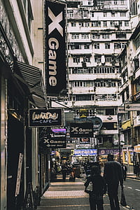 man and woman walking beside building thumbnail