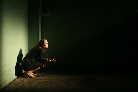 woman in long sleeve shirt squat on floor inside room thumbnail