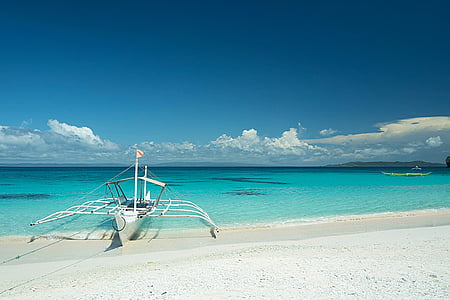 white boat on shoreline thumbnail