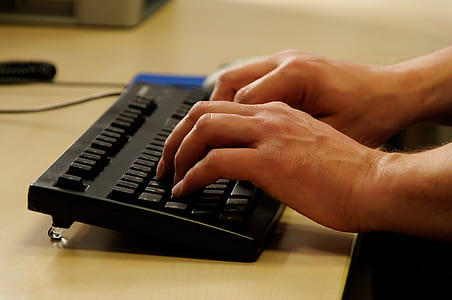 selective focus photo of person typing on black keyboard thumbnail