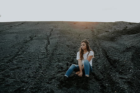 woman sitting on black ground thumbnail