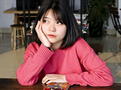 woman resting her right cheek on her right hand thumbnail