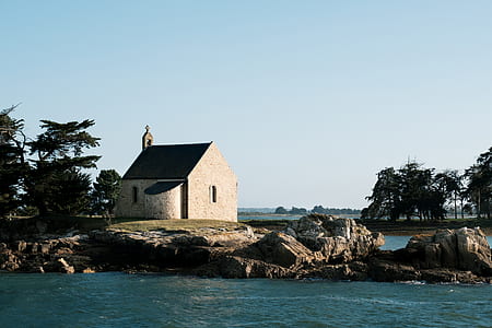 church beside river and trees during daytime thumbnail