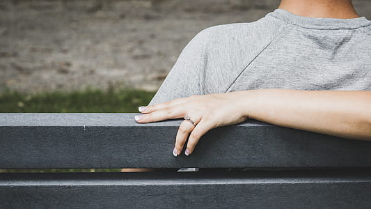 person sitting on bench during daytime thumbnail