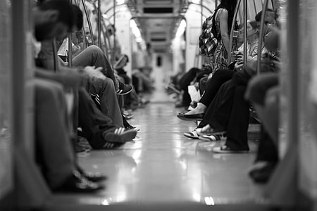 grayscale photography of people sitting in train thumbnail
