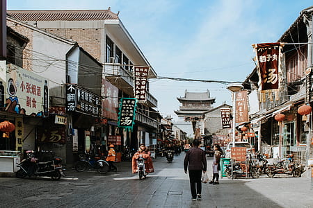 landscape photography of people at sidewalk china town thumbnail