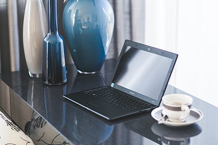black laptop computer turned off near coffee thumbnail