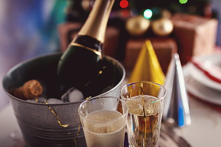 Glasses and bottle of Champagne in an ice container. Happy New Year concept. thumbnail