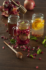 three clear glass mugs filled with beverages on brown wooden table thumbnail