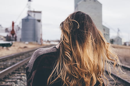 woman standing near train rails thumbnail