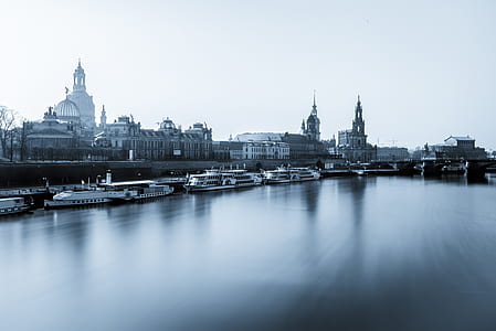 city beside body of water with sail boats thumbnail