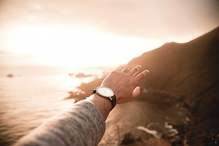 person raising hand during golden hour thumbnail