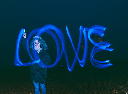 woman standing standing beside love text thumbnail