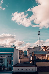 transmission tower surrounded with buildings thumbnail