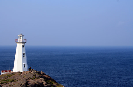 white lighthouse near sea at daytime thumbnail