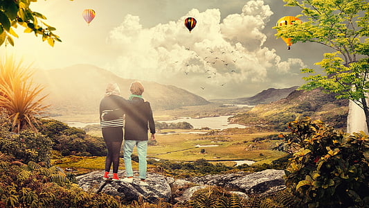 two women watching hot air balloons in sky thumbnail
