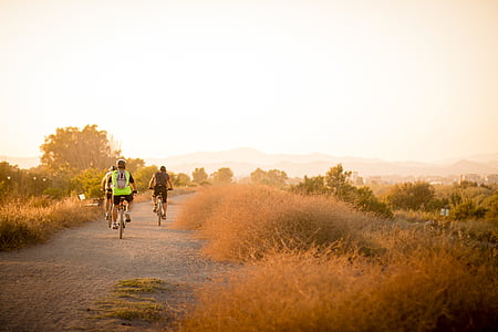 three men riding bicycles at middle of street thumbnail