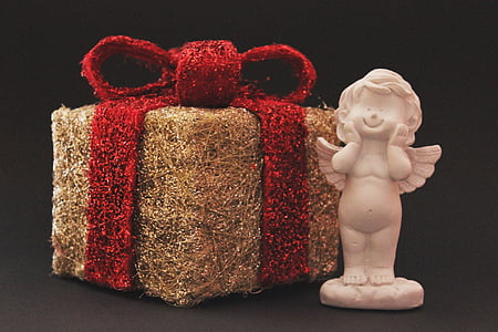 brown and red gift box and cherub figurine thumbnail