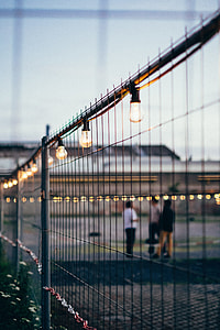 selective focus photo of filament bulbs on black metal fence thumbnail