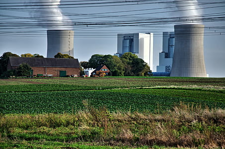 photo of brown concrete house beside factory thumbnail