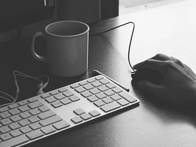 white Apple keyboard with white ceramic mug thumbnail