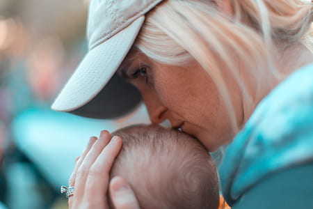 woman kissing child's head thumbnail
