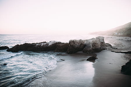 gray rock formation near seashore thumbnail