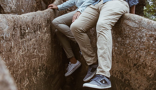 man and woman sitting on brown wall thumbnail