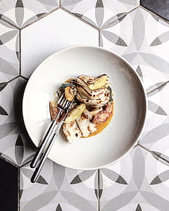 Stainless Steel Fork and Knife on White Ceramic Plate thumbnail