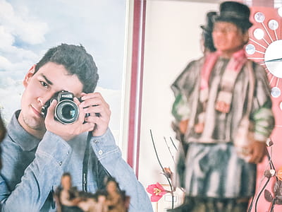 Man in Blue Denim Jacket Using Black Dslr Camera thumbnail