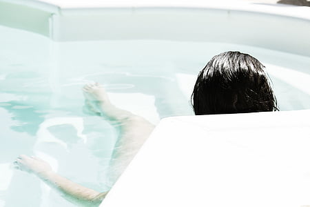 woman on swimming pool during daytime thumbnail