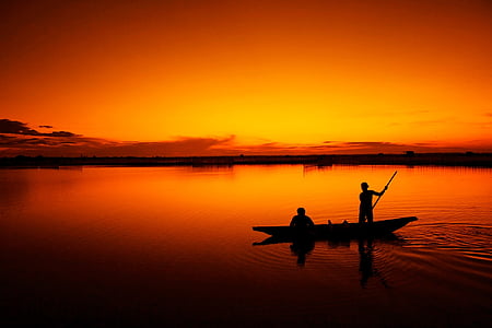 silhouette of two men on canoe during sunset thumbnail
