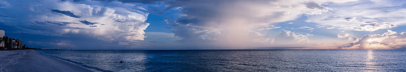 body of water under white clouds and blue sky thumbnail