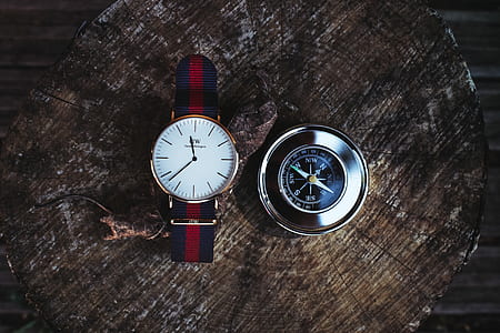 Round Silver-colored Analog Watch Beside Compass thumbnail