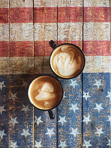 two cups of coffee on USA flag printed board thumbnail