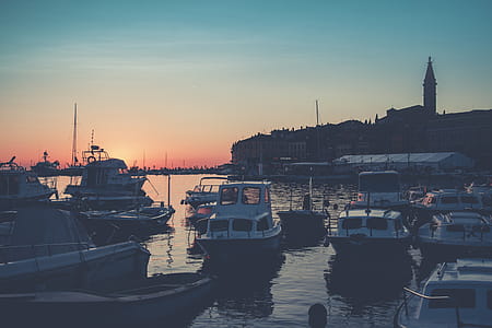 Bunch of Boats on Body of Water during Golden Hour thumbnail