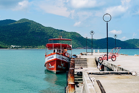 red and white yacht on dock thumbnail