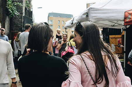 two woman walking on the road photo thumbnail