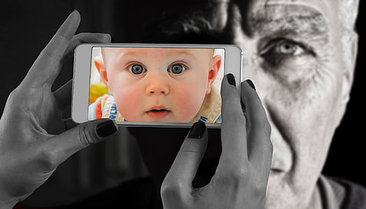 selective color photo of baby in beige top thumbnail