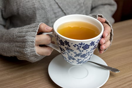 Female hands holding hot cup of tea thumbnail
