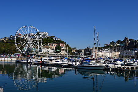 boats on body of water near ferris wheel thumbnail