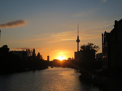 body of water between buildings at golden hour thumbnail