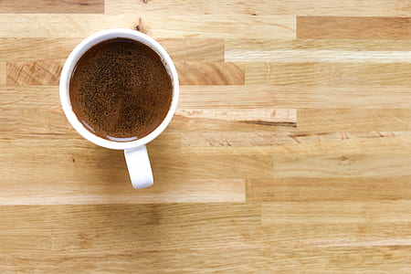 white mug filled with brown coffee thumbnail