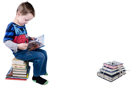 boy in blue long-sleeved shirt reading a book thumbnail