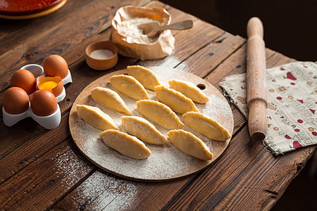 unbaked pastry on top to round brown tray thumbnail