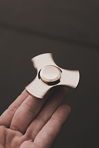 person holding fidget spinner thumbnail